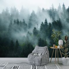 a living room with a wall mural that has trees in the background and fog on the ground