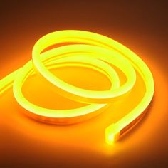 a neon yellow glower on a dark background with the cord still attached to it