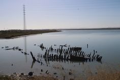 a body of water surrounded by land and power lines