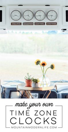 three clocks are hanging on the wall above a table with flowers in vases and potted plants