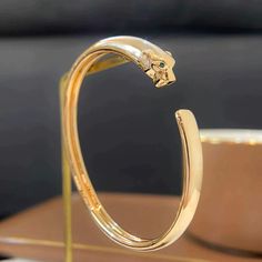 PANTHERE GOLD OPEN BRACELET Classic Gold Cartier Bangle, Cartier Jubilee Gold Bracelet, Modern Gold Cartier Bracelets, Cartier Gold Bangle With Polished Finish, Modern Gold Cartier Bracelet, Cartier Yellow Gold Bangle Bracelet, Cartier Polished Gold Bangle, Luxury Gold Cartier Bracelet, Cartier Elegant Rose Gold Bracelet