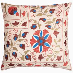 an embroidered pillow with red, blue and green flowers on the front is featured in this image