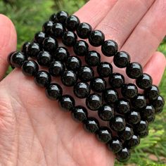 "Black Onyx Bracelet - natural, genuine, round crystal beads Weight: 17-18g Bracelet Size: 6.50\"-6.75\" Bead Size: ~8.25mm This listing is for one Black Onyx crystal bracelet. Stones are round beads. Your bracelet will be chosen for you randomly. Photos show the examples. Bracelets are stretchable. They could be used for crystal healing, meditation, or as a jewelry. These bracelets are not returnable. Onyx is good for decision-making. It brings luck and happiness in the home. It helps with grie Black Beads Crystal Bracelet Gift, Gift Crystal Bracelet With Black Beads, Healing Black Beaded Bracelets, Bracelet Stones, Crystal Meditation, Onyx Crystal, Black Onyx Bracelet, Crystals Healing, Types Of Crystals