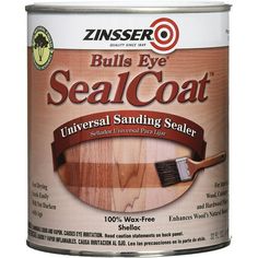 a can of sealcoat with a wooden handle and brown paint on the inside of it