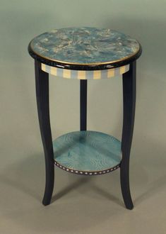 a blue and white table sitting on top of a gray floor