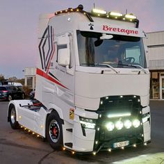 a large white truck with lights on it's headlights