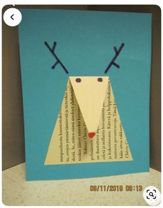 an origami reindeer made out of paper on a blue background with words written in it