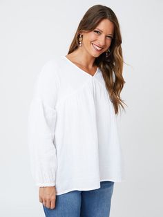 Cut from a soft, gauzy white cotton, this boho top makes every day feel like a beach day. There's something about an effortless statement earring that really brings out the best in this lightweight top with an easy fit. Fit Note: Designed to be roomy and flowy. Those that prefer a more fitted garment or that are in between sizes will want to size down 100% cotton Length of size M is 27" from top of bodice Made fair trade in India by one of our longstanding production partners Breezy Relaxed Fit V-neck Tops, Breezy V-neck Tops With Relaxed Fit, White Relaxed Fit Breezy Tops, White Breezy Top For Day Out, Summer Long Sleeve Cotton Gauze Tops, Flowy Cotton Tops For Daywear, White Casual Airy Blouse, Spring Long Sleeve Cotton Gauze Tops, Spring Cotton Gauze Tops With Relaxed Fit