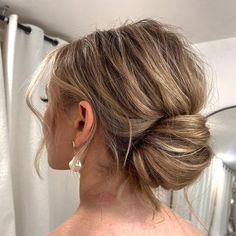 a woman with her hair in a low bun