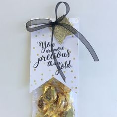 there is a card with gold foil on it and a ribbon tied around the top