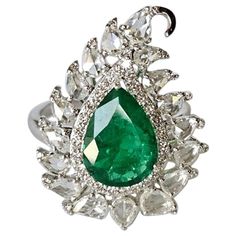 A very gorgeous and beautiful, one of a kind, Emerald Cocktail Ring set in 18K White Gold & Diamonds. The weight of the pear shaped Emerald is 2.27 carats. The Emerald is completely natural, without any treatment and is of Zambian origin. The combined Diamonds weight is 1.46 carats (Rose Cuts+ Round). Net 18K White Gold weight is 5.40 grams. The gross weight of the Ring is 6.16 grams. The dimensions of the ring are 2.60cm x 2.00cm x 0.50cm (L x W x D). The ring is made in US size 6.75 and can be Emerald Cocktail Ring, Emerald Cocktail, Zambian Emerald, Royal Jewelry, Emerald Gemstone, Zambia, Beautiful One, Rose Cut Diamond, Jewelry Rings Engagement