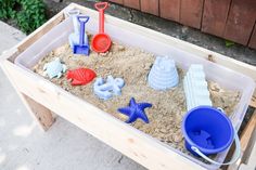 a sandbox filled with different types of toys