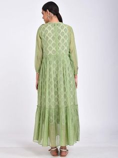 A delicate chanderi fit and flare-tiered long dress with 3/4th sleeves and flouncy hemline. The dress comes with a block printed offwhite soft cotton slip Features: Handwoven and hand block printed. 100% cotton silk fabric Handmade in India Garment measurements (in Inches): Size XS : Bust-34", Waist-Flared", Hip-Flared, Length-52" Size S : Bust-36", Waist-Flared", Hip-Flared, Length- 52" Size M : Bust-38", Waist-Flared", Hip-Flared, Length- 52" Size L : Bust-40", Waist-Flared", Hip-Flared, Lengt Summer Anarkali Dress With Ruffles, Traditional Tiered Skirt Dress For Spring, Traditional Spring Dresses With Tiered Skirt, Cotton Silk Fabric, Cotton Slip, Silk Maxi, Silk Maxi Dress, Dress Set, Green Cotton