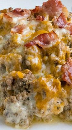 a white plate topped with meat and cheese covered casserole