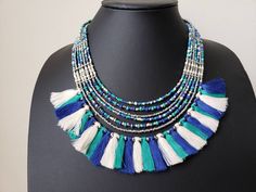 Colorful beaded fringe necklace with silk tassels. Perfect for vacation or resort wear. Sparkly silver color beads catch the light and dress it up. Perfect for day or night, Excellent quality. Shop more necklaces: https://www.etsy.com/shop/BoutiqueByMaryam?section_id=21694658 Shop BoutiqueByMaryam: https://www.etsy.com/shop/boutiquebymaryam Blue Bohemian Beaded Necklaces With Tassels, Bohemian Tassel Necklace With Colorful Beads For Beach, Bohemian Blue Beaded Necklaces With Tassels, Bohemian Tassel Necklace With Dangling Beads For Beach, Bohemian Tassel Necklace With Round Beads For Beach, Green Fringed Beach Jewelry, Multicolor Fringe Jewelry For Beach, Multicolor Fringe Jewelry For The Beach, Multicolor Fringe Beach Jewelry