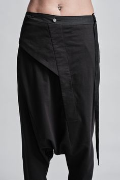 "Drop Crotch Trouser with Asymmetrical Front Closure__ // EXPRESS DELIVERY ONLY __Elastic Backside Waistband with Belt __2 Front Pockets __1 Rear Bonded Pockets __Asymmetrical Hidden Front Closure __Soft Cotton Fabric model__ bust 92 (36\"), waist 72 (28\"), hips 102 (40\"), biceps 28 (11''), height 177 (5'8\"), kg 65 (143 lbs) model wears size M | color: black fabric__ 100 cotton care__ delicate machine wash at 30 c wash inside out use cool iron do not tumble dry sizing__ size XS (US 4, EU 34, Asymmetrical Cotton Bottoms For Work, Versatile Workwear Bottoms With Asymmetrical Hem, Black Asymmetrical Hem Workwear Pants, Black Pants With Asymmetrical Hem For Work, Black Asymmetrical Hem Pants For Work, Black Baggy Asymmetrical Bottoms, Black Asymmetrical Baggy Bottoms, Modern Asymmetrical Black Bottoms, Black Asymmetrical Hem Bottoms For Work