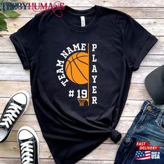 a t - shirt that says namme p player with a basketball in it on top of a wooden table