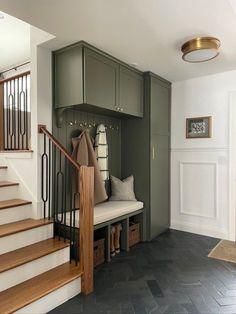 an entryway with stairs and storage boxes