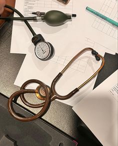 a doctor's stethoscope sitting on top of a desk next to medical supplies