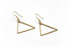 "Lightweight, geometric triangle earrings perfect for your next day out in the summer sunshine. ▲ Brass triangles measure approx. 1 1/4\" ▲ Gold-plated surgical steel earring hooks (hypoallergenic) We try to display product colors as close to life as possible. However, all monitors are different and so there might be slight color variations from screen to screen. CARE INSTRUCTIONS Jewelry should be kept away from moisture as much as possible. Remember to take your jewelry off before swimming and Adjustable Minimalist Earrings For Summer, Minimalist Adjustable Earrings For Summer, Minimalist Earrings For Summer, Minimalist Triangle Earrings For Everyday, Minimalist Metal Earrings For Summer, Handmade Minimalist Triangle Earrings, Minimalist Nickel-free Triangle Earrings, Minimalist Summer Earrings With Ear Wire, Minimalist Handmade Triangle Earrings