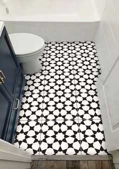 a bathroom with black and white floor tiles in the shape of an octagon