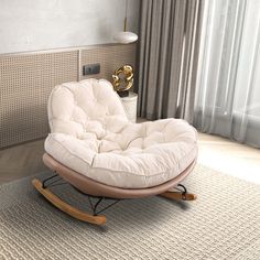 a white rocking chair sitting on top of a rug