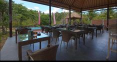 an outdoor dining area with wicker chairs and tables