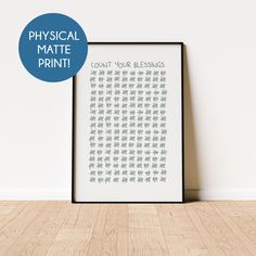 a poster with the words physical matter print on it next to a wooden floor in front of a white wall