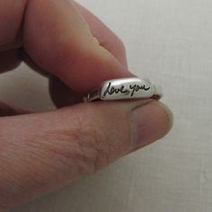 "This sterling silver handwriting ring is personalized with your ACTUAL handwriting. The handwriting is deeply engraved and the engraving is blackened to bring out the detail. Handmade using sterling silver, the handwriting layer will measure approx. 3/16\" and the length will be based on your handwriting. I don't recommend anything longer than 5/8\", especially on size 7 or smaller rings. The ring shank is approx. 1/8\" (4mm) wide and is approx. 1.5mm thick. Please send your handwriting image b Hand Stamped Sterling Silver Engraved Ring, Hand Stamped Sterling Silver Engraved Ring As Gift, Classic Sterling Silver Hand Stamped Engraved Ring, Meaningful Engraved Promise Ring With Engraving Option, Meaningful Engraved Ring For Promise, Meaningful Promise Ring With Engraving Option, Meaningful Engraved Ring As A Gift, Promise Sterling Silver Ring With Engraved Text, Promise Sterling Silver Engraved Ring