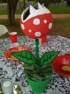 a table topped with a potted plant covered in red and white polka dots