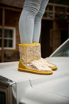 Spice up your shoe game with Smaibulun Ugg's Dallas Glam Sequin Shearling Boots! The perfect blend of style and comfort, these boots feature playful yellow glam sequins and cozy shearling lining. Who says ugg footwear has to be boring? (No one, that's who!) 1'' heel 7.6'' shaft 15.8'' circumference Pull-on Suede upper & Man-made sequins Faux fur lining EVA sole