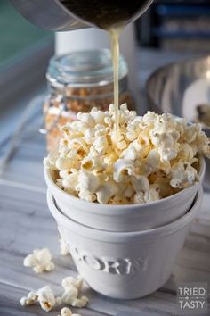 a white bowl filled with popcorn sitting on top of a table