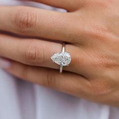 a woman's hand with a diamond ring on it