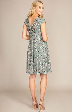 Our Alessandra maternity dress is a trusted favourite Tiffany Rose design. Now introducing our summer sage-green ditsy floral print. Breastfeeding friendly cross-over neckline, grown-on sleeves for that extra upper arm coverage and a full swishy skirt that falls to the knee. This maternity style is perfect for every event, from brunch with friends to wedding guest chic. Ditsy floral print in olive/sage green with flecks of orange and pink detail Soft premium stretch jersey fabric / Cross-over ne Green Surplice Neckline Dress For Garden Party, Green Short Sleeve Maternity Dress For Summer, Green Short Sleeve Maternity Dress, Fitted Green Maternity Dress With Short Sleeves, Casual Green Maternity Dress, Green Summer Maternity Dress, Green V-neck Maternity Dress, Green V-neck Maternity Dress For Summer, Fitted Floral Print V-neck Maternity Dress