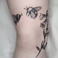 a black and white photo of a bee on the side of a woman's leg