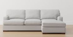 a white couch sitting on top of a hard wood floor