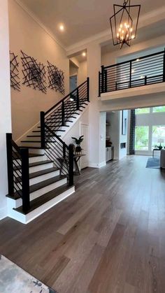 a large open floor plan with wood floors and white walls