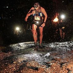 a man running in the rain at night