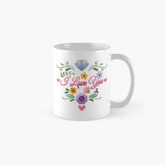 a white coffee mug with flowers and the words i love you written in red on it