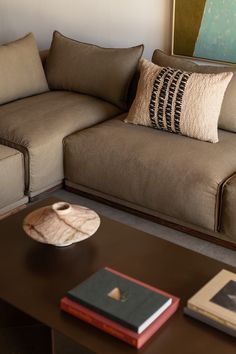 a living room with a couch, coffee table and pictures on the wall