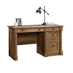 a wooden desk with two drawers and a lamp on top