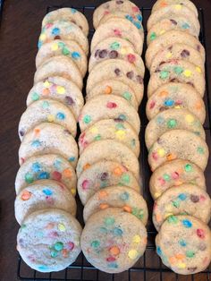 cookies with sprinkles and colored candies on a cooling rack