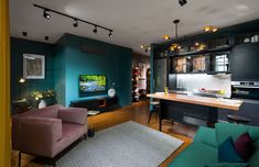 a living room filled with furniture and a flat screen tv mounted to the wall above it