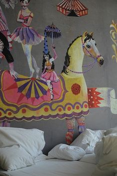 a bedroom with a large mural on the wall