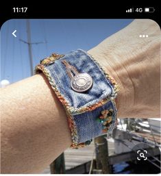 a person's arm with a bracelet made out of jeans