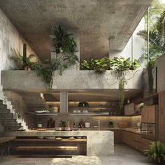 an open kitchen with plants growing on the wall and stairs leading up to the second floor