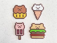 four perlery shaped magnets with animals and ice cream on them, all in different colors