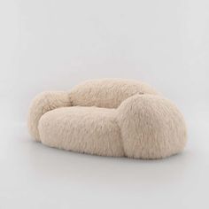 an animal shaped chair made out of sheep's wool on a white background,