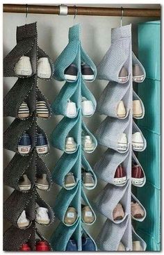 several pairs of shoes hanging on a rack in front of a wall mounted shoe rack