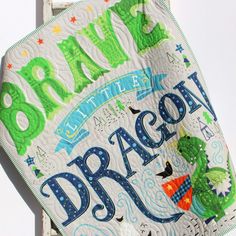 a quilt kit with the words dragon written in blue and green on it's back